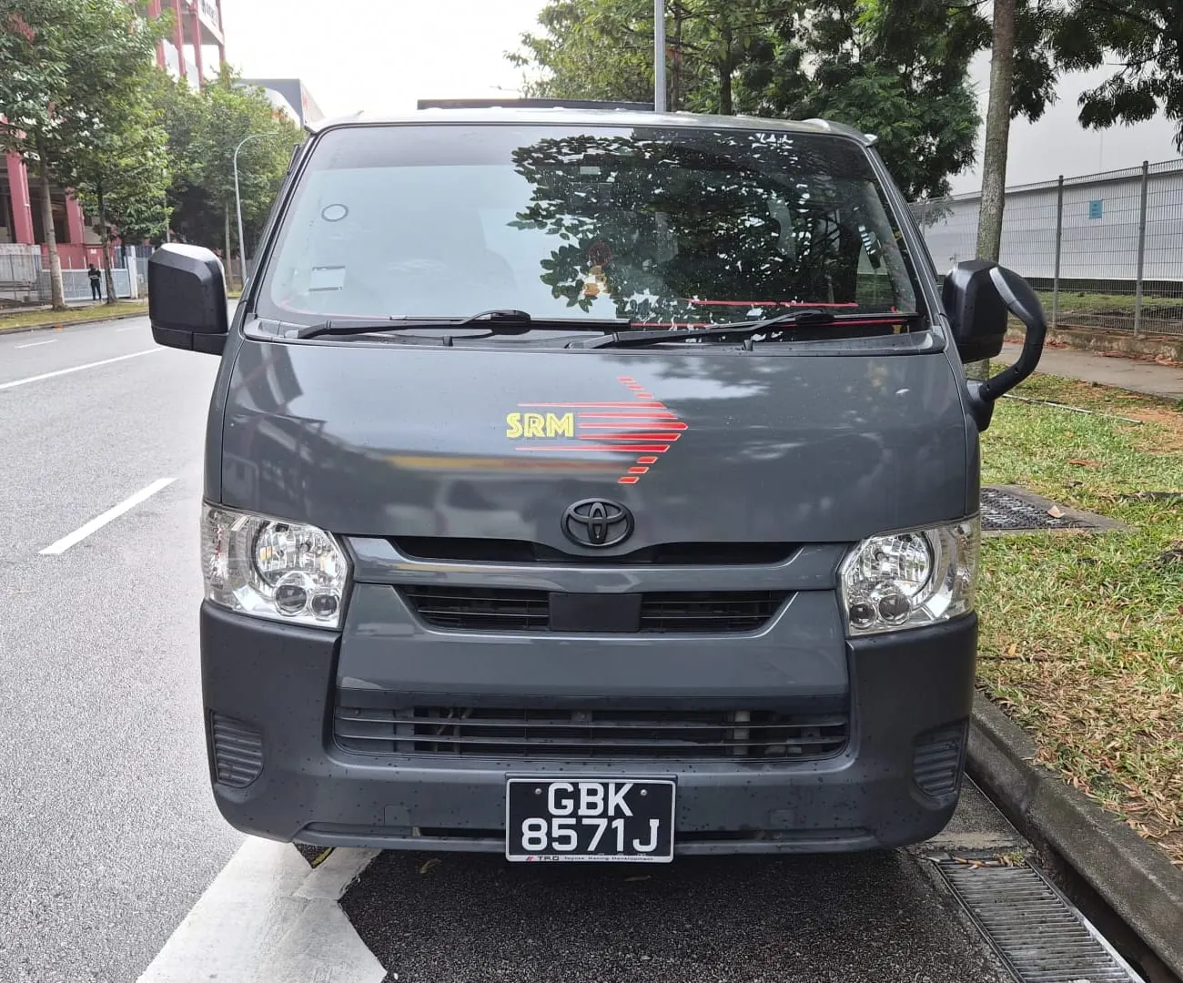 Row of SRM Logistics vans in company livery, front three-quarter view.
